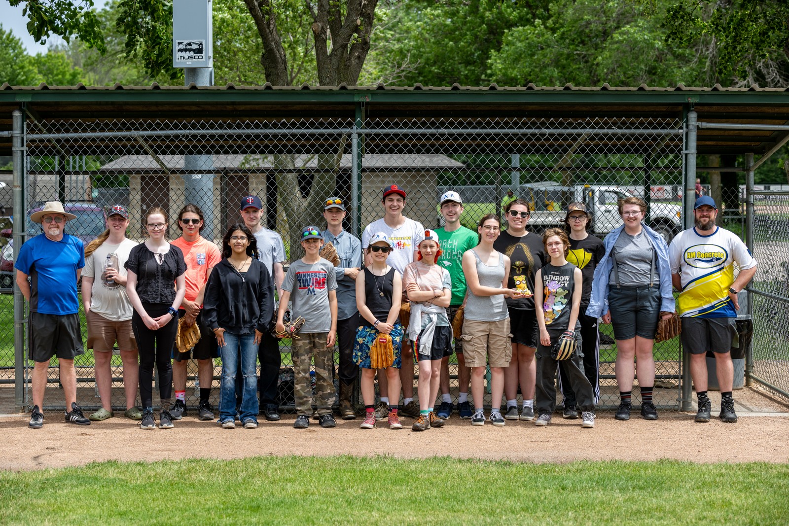 People standing on a baseball sideline