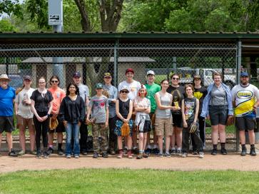 People standing on a baseball sideline